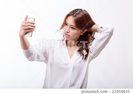 Asian woman with smart phone taking a selfie Asian woman with smart phone taking a selfie 22850633