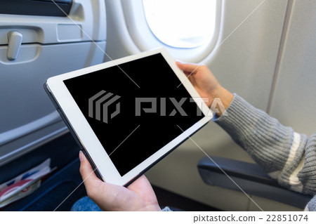 Woman use of the digital tablet in plane Woman use of the digital tablet in plane 22851074