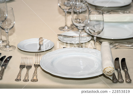 Table setting forks, knifes, plates, wineglasses. Table setting forks, knifes, plates, wineglasses. 22853819