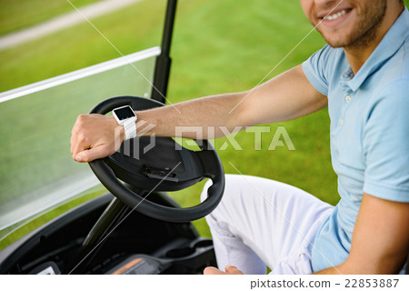 Smiling guy driving golf cart 22853887