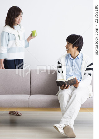 Husband reading a book with his wife 22855190