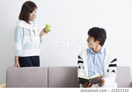 Husband reading a book with his wife Husband reading a book with his wife 22855192