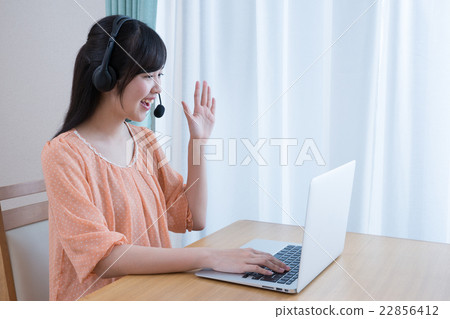 School girls in private clothes (PC, Internet learning, headset) 22856412