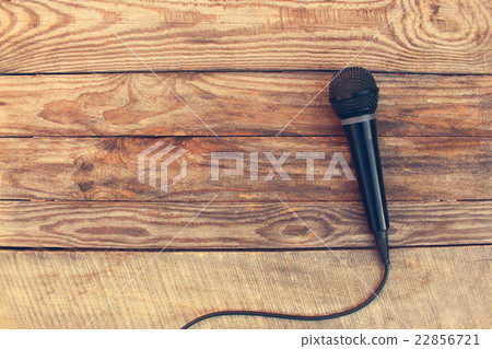 Microphone on wooden background. Toned image. 22856721