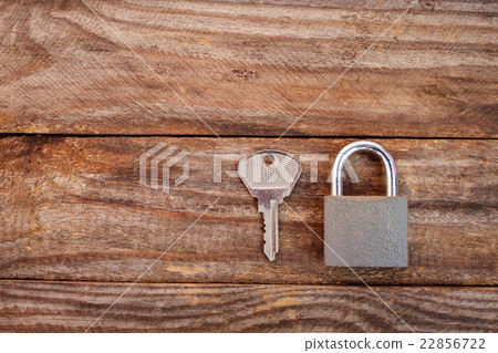 key and lock on wooden background 22856722