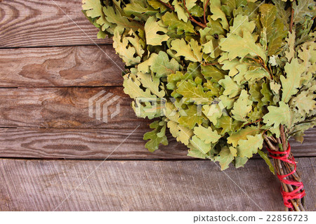 Oak broom for a bath on wooden background.  22856723
