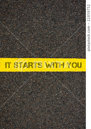 Road marking yellow line words IT STARTS WITH YOU 22859752