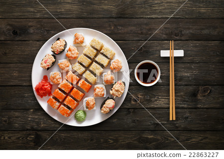 Set of sushi maki and rolls at wood background Set of sushi maki and rolls at wood background 22863227