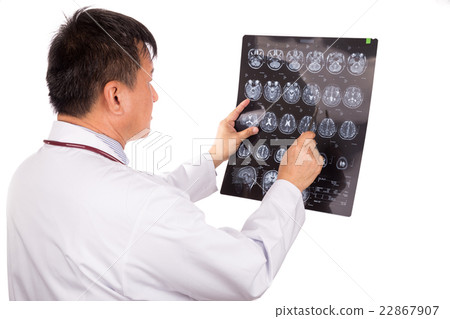 Asian neurology doctor examining head MRI images Asian neurology doctor examining head MRI images 22867907