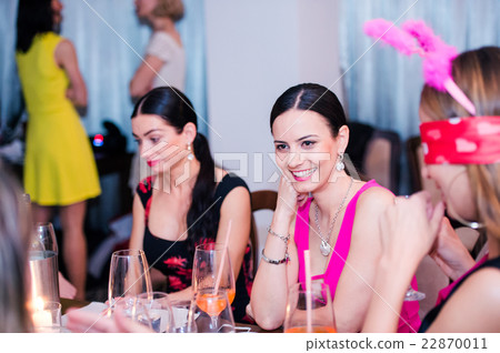 Cheerful bride and bridesmaids celebrating hen 22870011