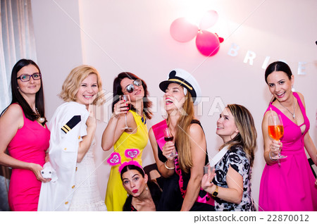 Cheerful bride and bridesmaids celebrating hen Cheerful bride and bridesmaids celebrating hen 22870012
