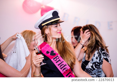 Cheerful bride and bridesmaids celebrating hen Cheerful bride and bridesmaids celebrating hen 22870013
