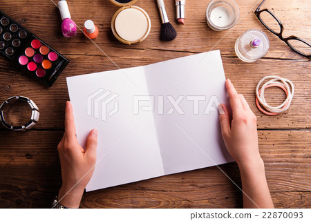 Hand of woman holding empty greeting card. Make-up Hand of woman holding empty greeting card. Make-up 22870093