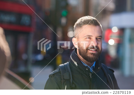 Hipster manager in black jacket walking in the 22870119