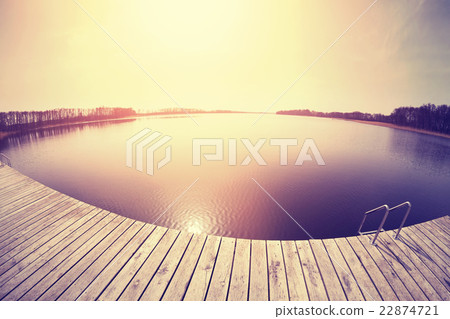 Vintage toned fisheye lens picture of a pier. 22874721