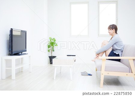 A woman watching TV 22875850