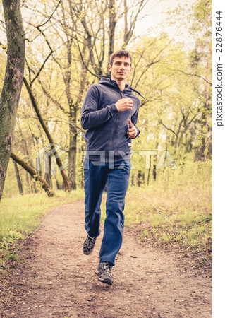 Young trail runner man jogging in the morning park 22876444
