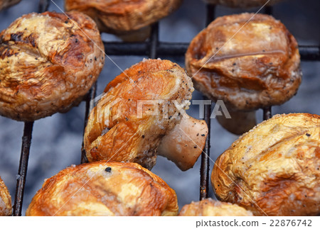 White champignons mushrooms on grill 22876742