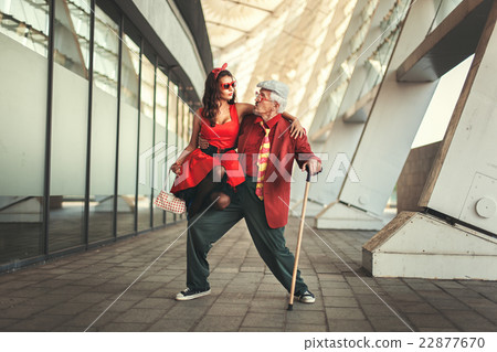 Young girl is dancing with the old man. Young girl is dancing with the old man. 22877670