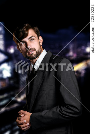 Businessman on night cityscape background Businessman on night cityscape background 22880228