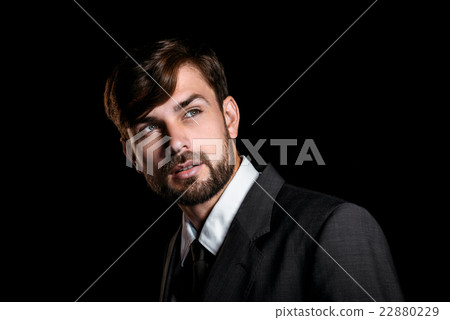 Handsome businessman on black background Handsome businessman on black background 22880229