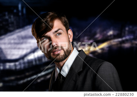 Businessman on night cityscape background Businessman on night cityscape background 22880230
