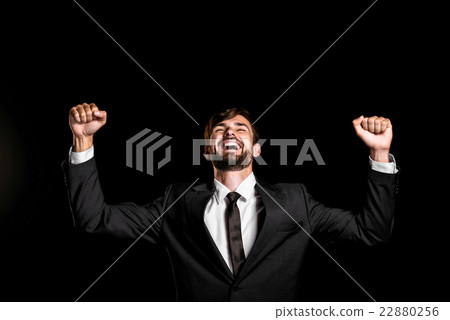 Handsome businessman on black background Handsome businessman on black background 22880256