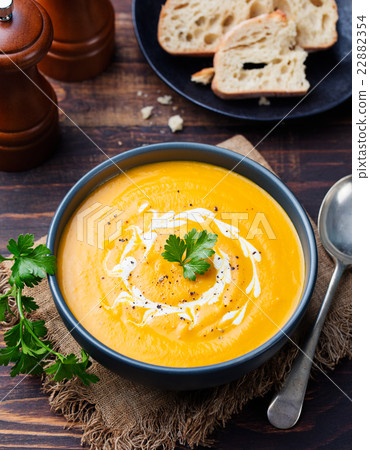 Pumpkin and carrot soup with cream and parsley Pumpkin and carrot soup with cream and parsley 22882354