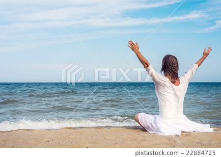 Woman meditating at the sea Woman meditating at the sea 22884725