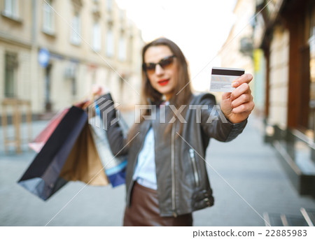 Beautiful woman with shopping bags and credit card 22885983