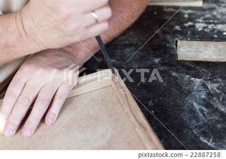 Carpenter is working with chisel. Furniture. 22887258
