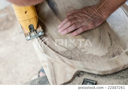 Carpenter is cutting a board with fretsaw Carpenter is cutting a board with fretsaw 22887261