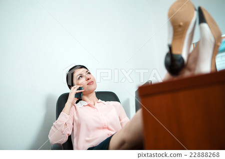 Relaxed business woman sitting in a chair with Relaxed business woman sitting in a chair with 22888268