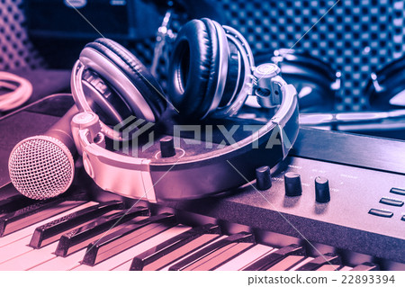 microphone,headphones on piano background. microphone,headphones on piano background. 22893394