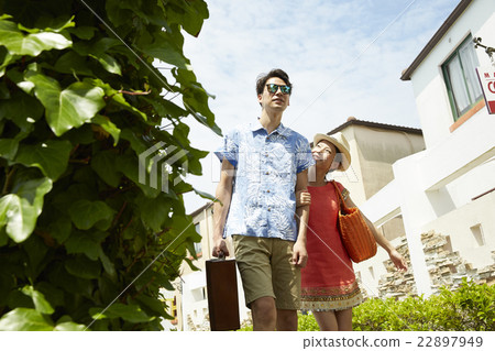 A couple walking on a resort 22897949