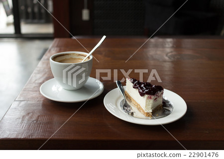 Hot cappuccino coffee served with blueberry cake Hot cappuccino coffee served with blueberry cake 22901476