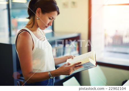 Woman reading book in beautiful light interior  22902104