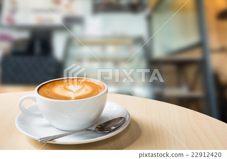 Hot art Latte Coffee in a cup on wooden table Hot art Latte Coffee in a cup on wooden table 22912420