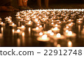 One Person Placing Candle to the Group of Candles 22912748