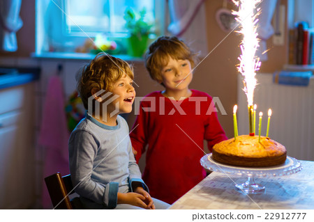 little boys celebrating birthday and blowing little boys celebrating birthday and blowing 22912777