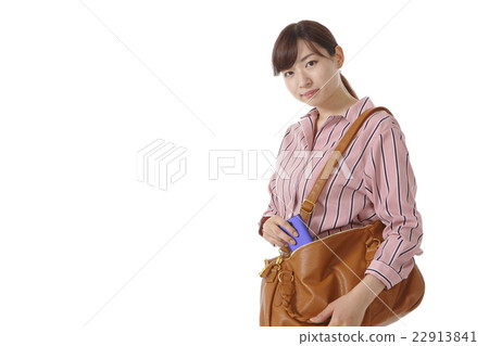 A young lady who takes out a cell phone A young lady who takes out a cell phone 22913841