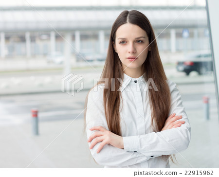 Confident business woman standing in office Confident business woman standing in office 22915962