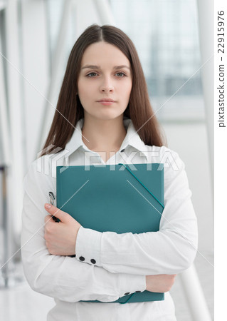 Friendly business woman holding folder Friendly business woman holding folder 22915976
