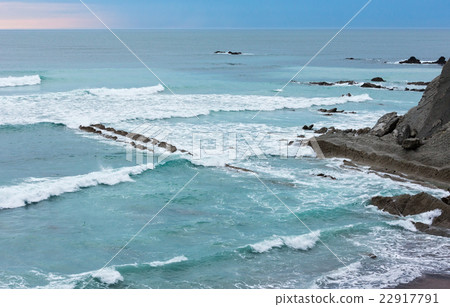 Evening ocean rocky coast. 22917791