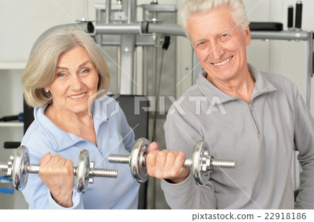 senior couple exercising in gym senior couple exercising in gym 22918186