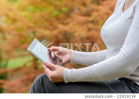 Woman with tablet PC in her hands 22919134