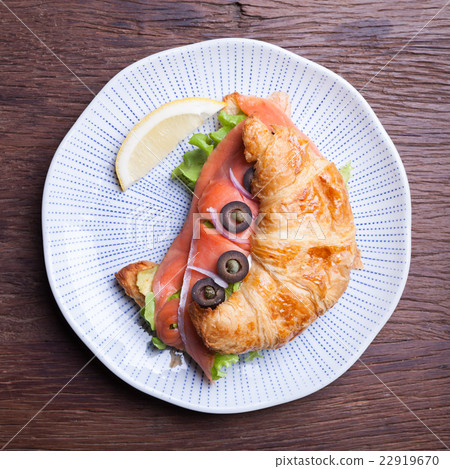 Croissant with salmon and capers Croissant with salmon and capers 22919670
