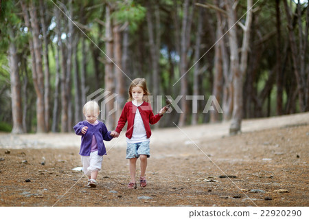 Two sisters having a walk in the woods Two sisters having a walk in the woods 22920290