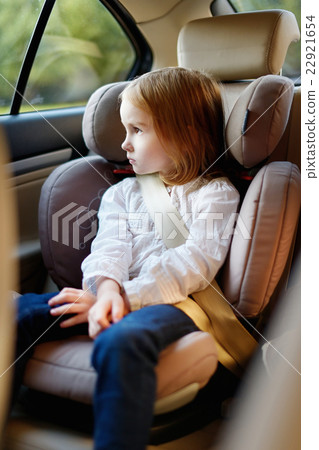 Adorable little girl sitting in car seat 22921654