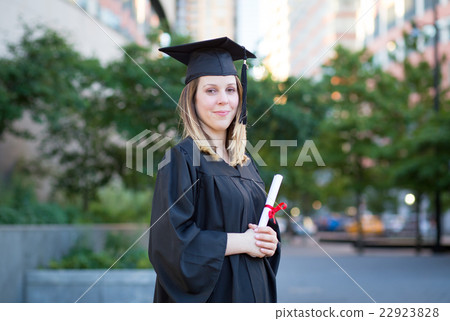 Female college student in graduation cap and gown Female college student in graduation cap and gown 22923828